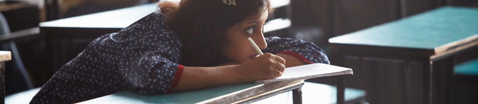 School girl at her desk in a classroom